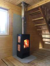 Популярный камин с дровницей Сибирь 8 в интерьере фото в Мозыре