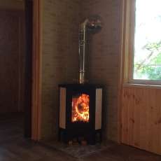 Стальной камин с большим стеклом Бавария угловая Амазонка бай фото в интерьере в Мозыре